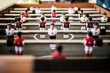 A close up picture of a fusball table