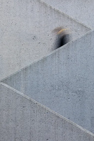 An image of a blurred person descending a concrete staircase