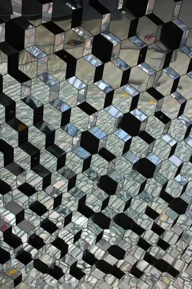 A mirrored wall comprised of three-dimensional hexagonal shapes