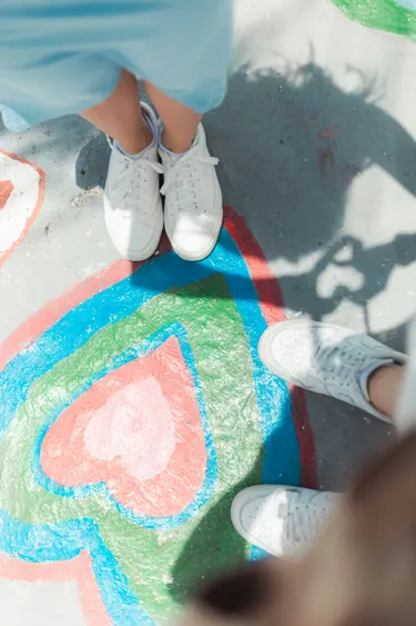 A photo of two white sneakers being looked down on from above